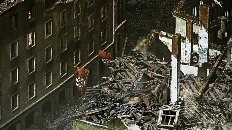 Auf dem Bild sind Hakenkreuz-Fahnen an zerstörten Häusern zu sehen.
