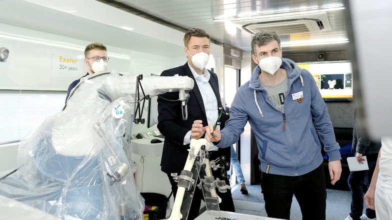 Dr. Volkmar Mehliß vom Elblandklinikum (rechts) an dem roboterarmgestützten Operationssystem. Daneben steht Dr. Thomas Dusing vom St. Elisabeth-Krankenhaus Leipzig. Er arbeitet schon eine Weile mit dem System.