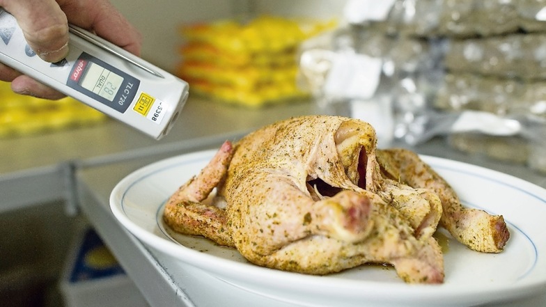 Ein Lebensmittelkontrolleur überprüft die Temperatur eines Hähnchens. Die Ergebnisse solcher Kontrollen gelangten bisher selten an die Öffentlichkeit. Verbraucherschützer möchten das ändern.