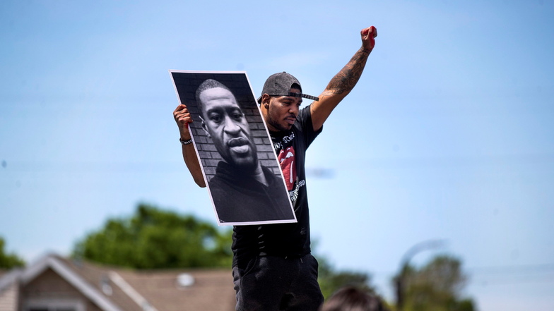 Tony L. Clark hält ein Foto des verstorbenen George Floyd. Gut ein Jahr nach der Tötung des unbewaffneten Afroamerikaners bei einem Polizeieinsatz beginnt in den USA das Hauptverfahren gegen den Hauptangeklagten.
