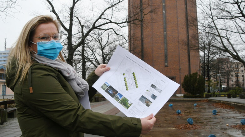Franziska Graetz, Mitarbeiterin im Bereich Stadtentwicklung in der Stadtverwaltung Weißwasser, zeigt den Plan für die künftige Gestaltung der Sprinbrunnenanlage vor dem Wasserturm in Weißwasser.
