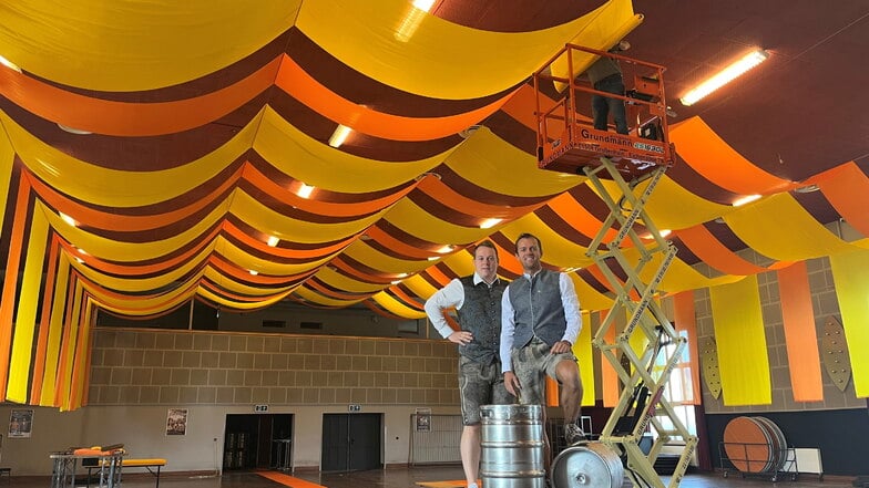 Kevin (l.) und Marcel Krause an der neuen Deko der Remontehalle Großenhain fürs Oktoberfest. Es findet zum ersten Mal hier statt.