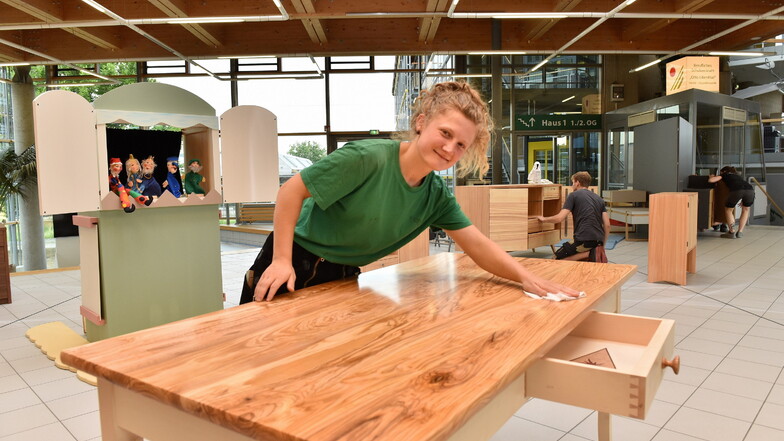 Felicia Weidensdörfer von der Tischlerei Auerbach und Hahn Grumbach mit ihrem Esstisch mit massiver Olivenholzplatte.