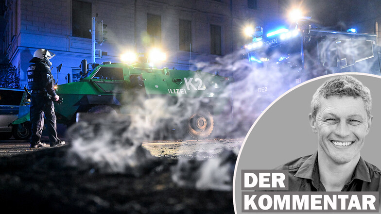 Polizisten stehen hinter einer rauchenden Barrikade im Stadtteil Connewitz in Leipzig, die zuvor gelöscht wurde.