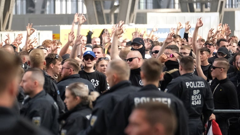 Teilnehmer der rechtsextremen Versammlung gegen den CSD im Hauptbahnhof von Leipzig zeigen das neonazistische Symbol von white power (dt. "weiße macht") mit den Händen.