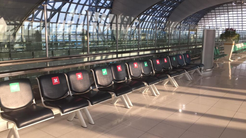 Schutz mit Symbolen: Auf dem Flughafen in Bangkok zeigen Symbole auf den Stühlen an, wo man sich hinsetzen darf, um den Mindestabstand einzuhalten.