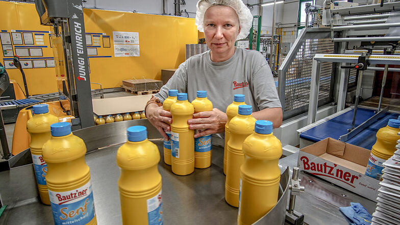 Sibylle Domagala arbeitet an der Verpackungslinie für Ein-Liter Flaschen. Täglich werden im Werk rund 90 Tonnen Senf abgefüllt.