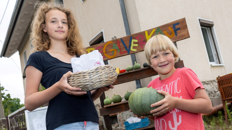 Kein Kürbis, sondern eine Zucchini. In ihrem Regalverkauf in Ziegra haben Svenja und Marek (von links) eine ganz besondere Form des beliebten Sommergemüses.