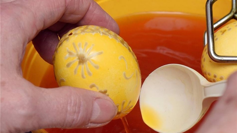 Erstes Farbbad Das Ei für zehn Minuten in Farbe tauchen, in die hellste zuerst. Das Ei danach vorsichtig mit einem Lappen abtupfen und trocknen lassen.