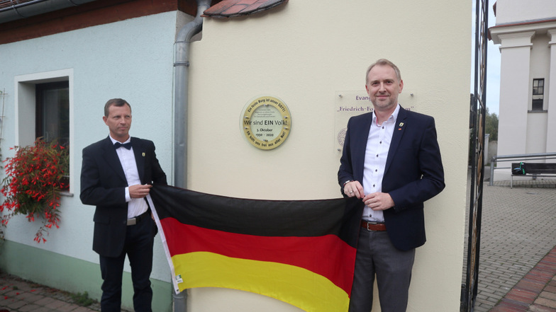 Eine Tafel – geschaffen von Metallbauer Martin Scholz – erinnert in Wittichenau an die friedliche Revolution 1989/1990. Am 3. Oktober wurde sie eingeweiht durch Bürgermeister Markus Posch (li.) und Mathias Kockert, Chef des CDU-Stadtverbandes.