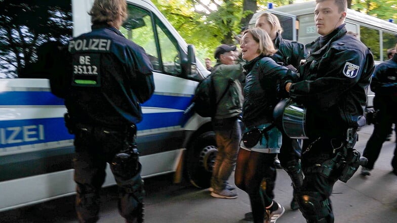 Juliane Nagel, sächsische Landtagsabgeordnete der Linken, wird von Polizisten zu einem Fahrzeug gebracht.