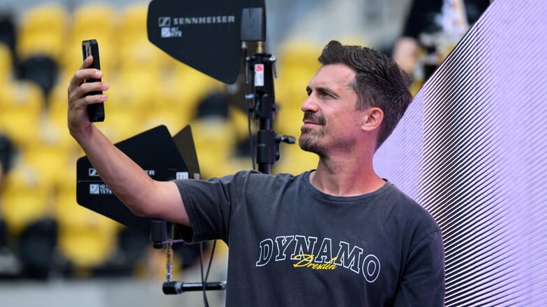 Ein Selfie vor dem Start der Partie: Dynamo-Trainer Thomas Stamm dreht eine Runde im noch recht leeren Rudolf-Harbig-Stadion.