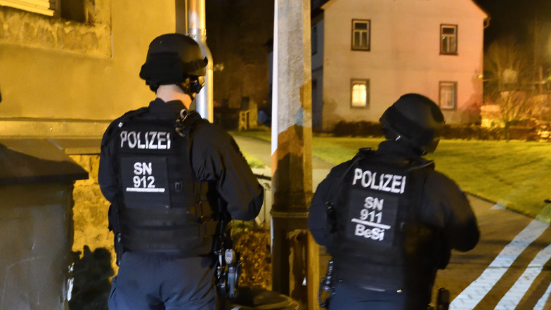 Schwer bewaffnete Polizisten beobachten am Mittwoch das Haus auf der Freiberger Straße, in dem Waffen vermutet werden