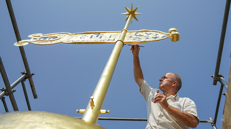 Wetterfahne und Stern fehlen derzeit auf dem Kirchturm in Hochkirch. Das Foto zeigt Schriftmaler Konrad Riedel aus Zittau, der 2018 Turmkugel und Wetterfahne neu vergoldet hatte.