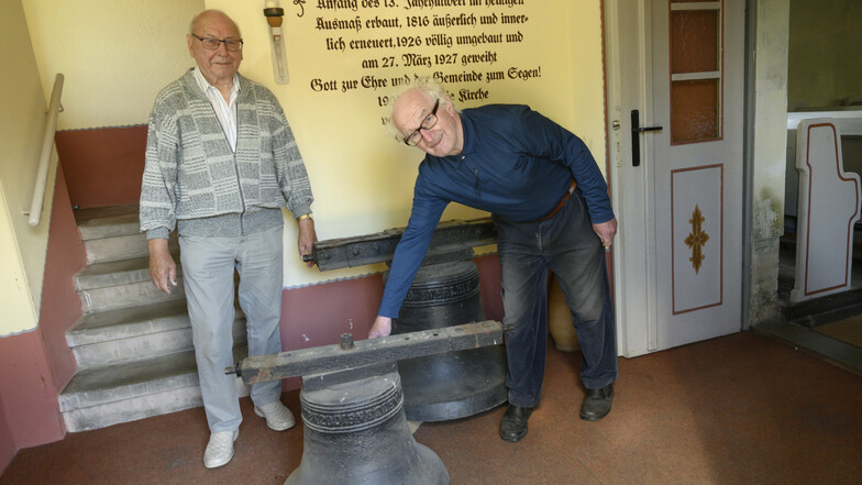 Manfred Neugebauer (links) und der Nünchritzer Prediger Christfried Seifert zeigen die alten gusseisernen Glocken, für die es keine Verwendung mehr gibt. Oder doch?