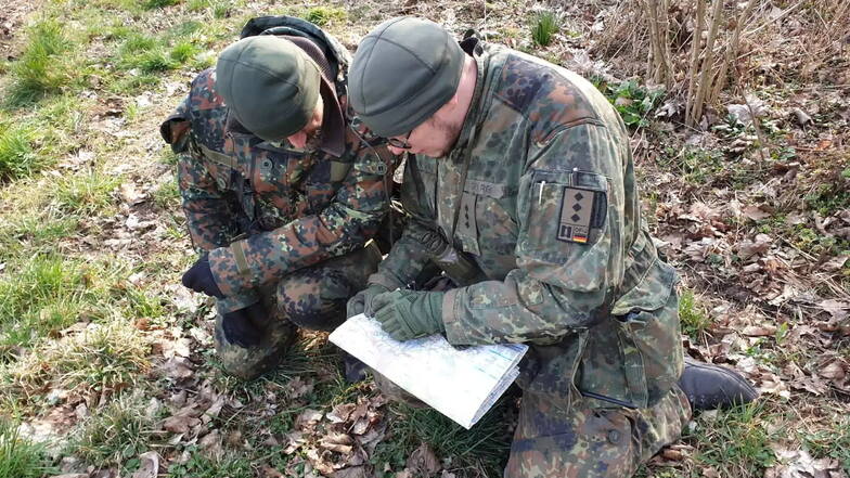 Der Vorsitzende der Reservistenkameradschaft Riesa, Patrick George (r.), bei der Ausbildung "Karte-Kompass" während eines Biwaks zum Thema "Leben im Felde".