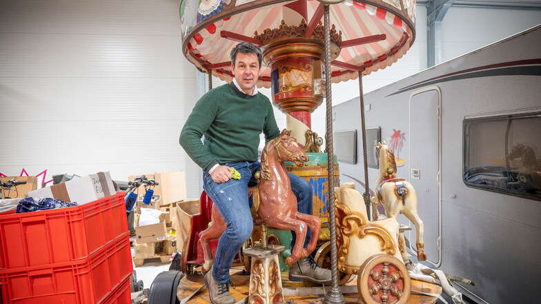 Torsten Pilz mit dem historischen Kinderkarussell, dessen Mittelteil von Künstler Sebastian Bieler auf Vordermann gebracht wird.