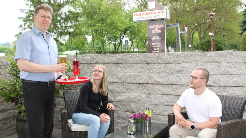 Gastwirt René Koark serviert in Dippoldiswalde seinen Gästen Michelle Wieland und Felix Schindler Cocktail und Bier.