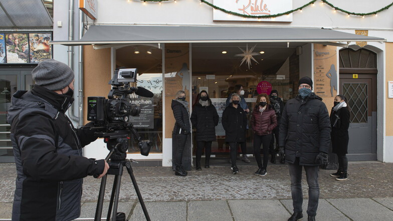 Das Welt-Fernsehen sendete am Montag live vom Großenhainer Frauenmarkt. Modehändler Ronny Rühle (rechts) nahm an der Aktion "Wir machen auf-merksam" teil, welche die Lage des Handels kritisiert.