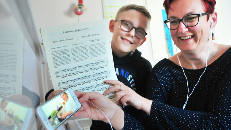 Das Lachen von Musiklehrerin Maren Göpel aus Wildenhain mit Sohn Johann täuscht. Um Keyboard-Schülerin Elsa (8) per Videotelefonie zu unterrichten, braucht sie starke Nerven.