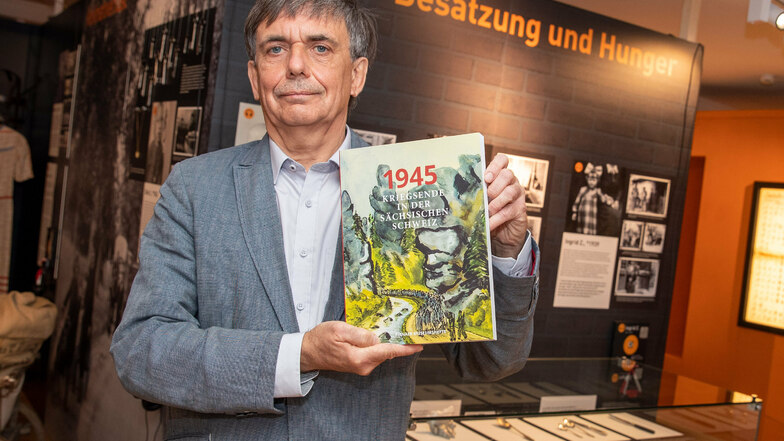 René Misterek, Leiter des Stadtmuseums Pirna, steht mit dem neuen Buch zum Kriegsende in der Ausstellung „Kriegskinder – Dialog der Generationen“