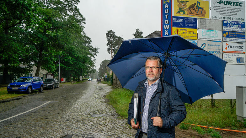 Schlechtes Wetter, gute Botschaft: Bürgermeister Swen Nowotny freut sich, dass der Gemeinderat von Königswartha die Sanierung der Eutricher Straße für 1,2 Millionen Euro beschlossen hat.