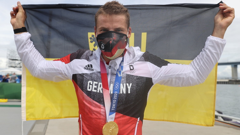 Der Dresdner Tom Liebscher jubelt mit der Stadtfahne über seinen zweiten Olympiasieg.
