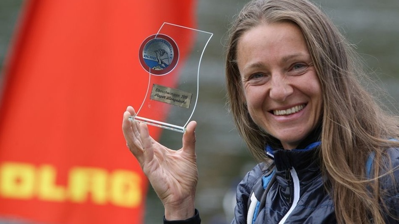 Gewonnen. Diana Schedretzky war die Schnellste. Die 44-Jährige aus Pirna kletterte auf der langen Distanz als Erste aus dem Wasser und erhielt den erstmals ausgelobten Pokal.