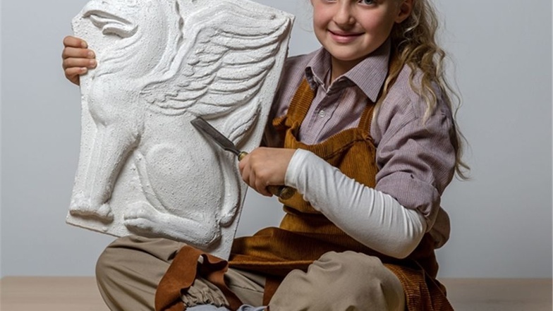 Charlotte-Elaine (8) aus Pirna stellt als erstes Adventskalenderkind den alten Beruf des Steinmetzes dar.