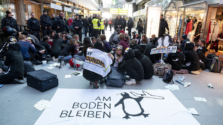 Demonstranten des Bündnisses "Am Boden bleiben" blockieren die Haupthalle des Flughafen Tegels.