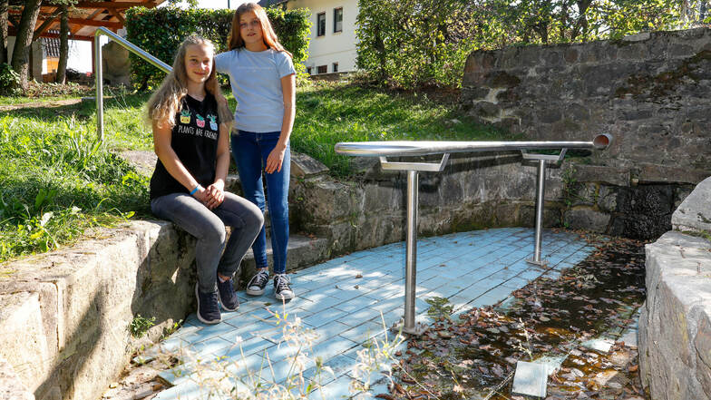 Emely (links) und Virgenie aus Lückendorf im ausgetrockneten Wassertretbecken. Die beiden haben den Oybiner Gemeinderäten gezeigt, wie man das anpackt.
