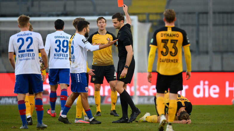 Schiedsrichter Max Burda zeigt Marco Hartmann, der am Boden liegt, die Gelb-Rote Karte. Dynamo muss die letzten Minuten in Unterzahl spielen.