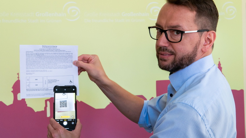 Die Moderne macht auch vor der Kommunalwahl nicht halt: Großenhains Wahlleiter Silvio Ihle zeigt, wie man Unterlagen zur Briefwahl mit einem QR-Code auf der Wahlbenachrichtigung anfordern kann.