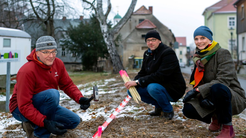 Am Friedhofsweg in Kleinwelka haben Ortsvorsteher Holger Jatzke (l.), Simon Schulze von der Brüdergemeine und die Bautzener Baubürgermeisterin Juliane Naumann die Stellen markiert, an denen Anfang 2022 fünf neue Winterlinden gepflanzt werden.