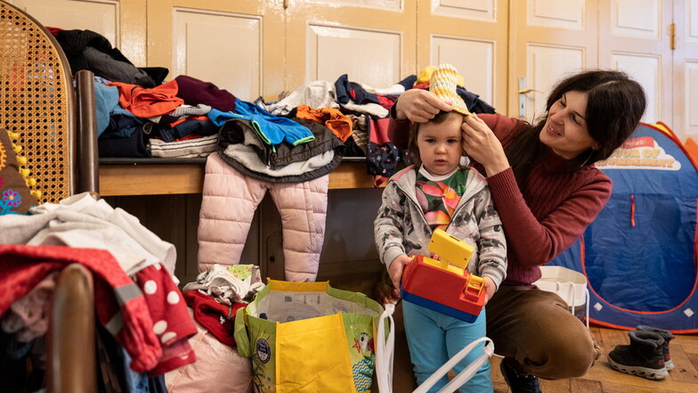 Hier lagern im Dippoldiswalder Bahnhotel Spenden für Flüchtlinge aus der Ukraine. Ania sucht für ihre Tochter Arina passende Kleidungsstücke.