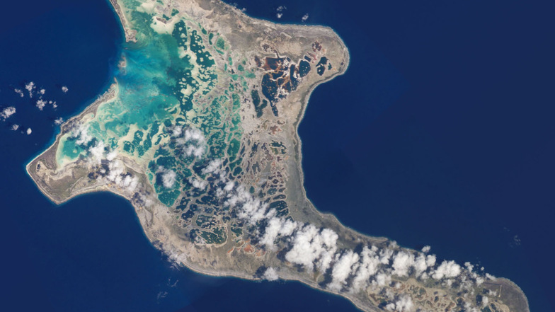 Wolken schweben über dem zum pazifischen Inselstaat Kiribati gehörenden Atoll Kiritimati. Kleine Inselstaaten sind durch einen steigenden Meeresspiegel vom Klimawandel unmittelbar betroffen.