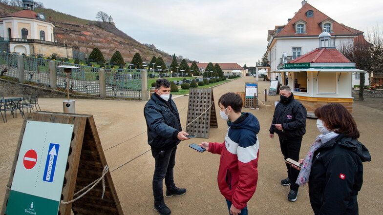 Mitarbeiter des Dresdner Sicherheitsdienstes kontrollieren am Eingang zum Staatsweingut Schloss Wackerbarth in Radebeul die Besucher.