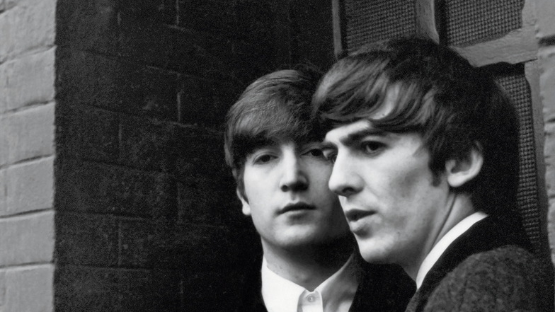 John Lennon (li.) und George Harrison in Paris.
