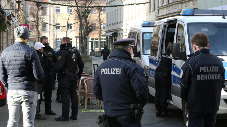 Auf dem Weg zum Polizeirevier: Beamte nehmen einen Maskenverweigerer in Pirna mit, der sich nicht ausweisen wollte.