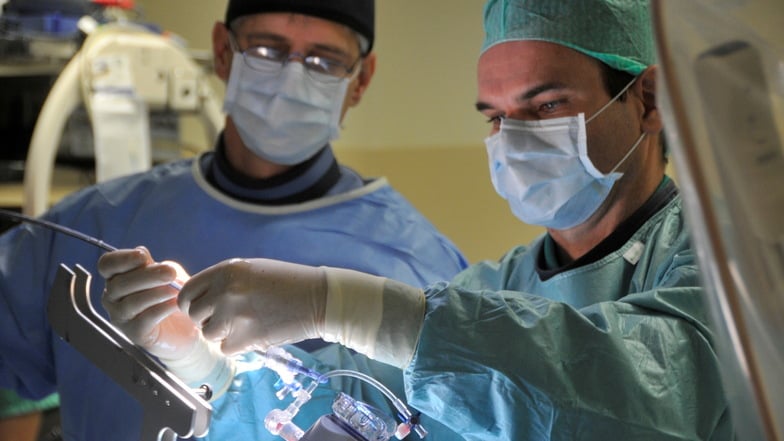 Professor Dr. Steffen Schön (r.) bei einer OP im Herzkatheterlabor: Mit kleinen Clips wird die Herzklappe repariert.