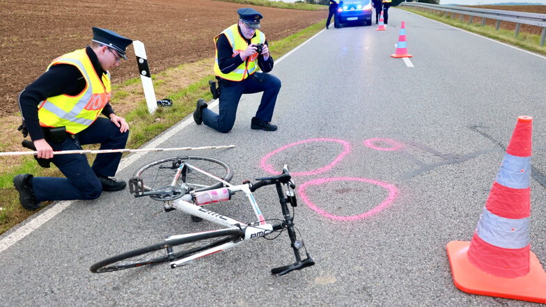 Polizisten bei der Unfallaufnahme nahe Lichtenhain. Untersucht wird, ob der Radfahrer wegen eines gesundheitlichen Problems stürzte.