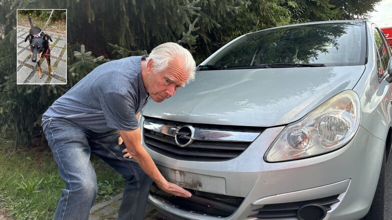 Dieter Puffe zeigt die Stelle an seinem Opel, an der der kleine Hund eingeklemmt war.