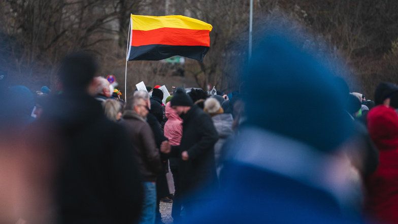 Ein 54-Jähriger soll bei einer Versammlung in Dresden eine Deutschlandflagge geschwenkt haben, auf der brennende Exkremente abgebildet waren. Nun reagiert die Staatsanwaltschaft.