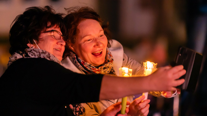 Sie sind begeistert: Zwei Frauen, die mit Kerzen beim ökumenischen Gottesdienst auf dem Schützenplatz in Bautzen dabei waren.