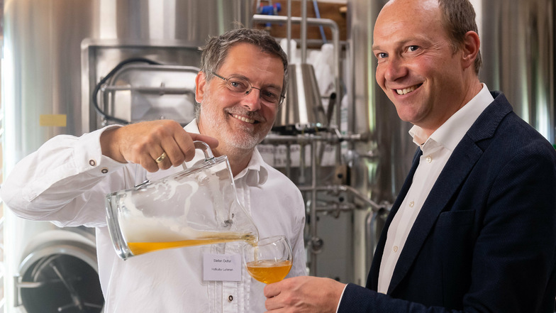 Stefan Oettel (links) braut Bier in Lohmen. Sachsens Landwirtschaftsminister Wolfram Günther erfuhr dort von Lebensmittelherstellern, welche Wünsche sie an Händler und Kunden haben.