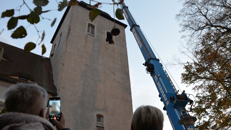 Da schwebt eine der Glocken aus dem Turm der evangelischen Kirche von Reichenbach.