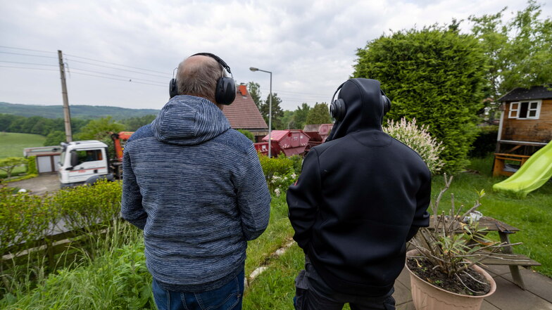 Asphalt schluckt Rollgeräusche nicht: Mitglieder der Bürgerinitiative Horkenstraße veranschaulichen mit übergestülpten Ohrenschützern, dass es vor ihren Wohnhäusern mitunter recht laut zugeht.