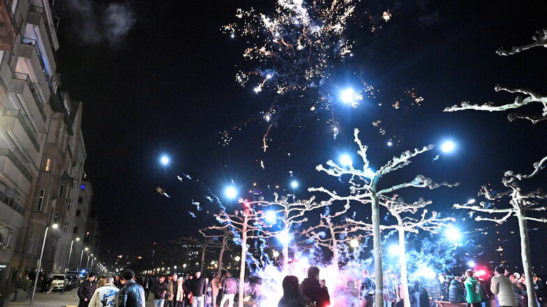 Menschen feiern an der Rheinpromenade in Düsseldorf ins Jahr 2023.