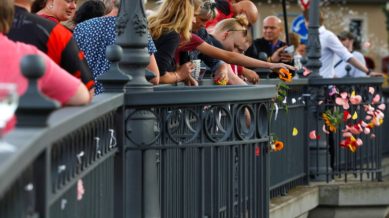 Bewegender Abschied: Hunderte Menschen haben am Montagabend von der Brücke an der Äußeren Oybiner Straße Blumen André Matthausch in die Mandau geworfen.