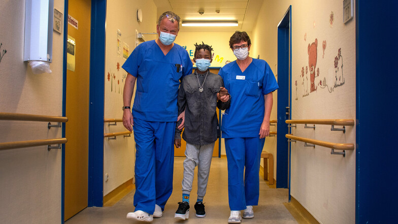 Dr. Reinhard Junghans und Dr. Ulla Lieser freuen sich mit dem 13-jährigen Louis aus Ruanda, dass er sein Bein behalten und sogar wieder ohne Unterarmstützen laufen kann.